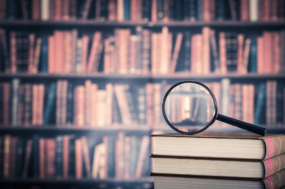 Magnifying glass on top of books