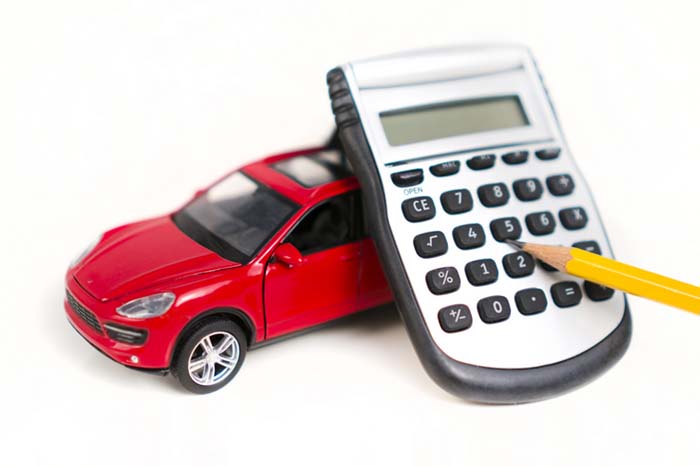 do-I-need-special-auto-insurance Toy car with calculator and pencil