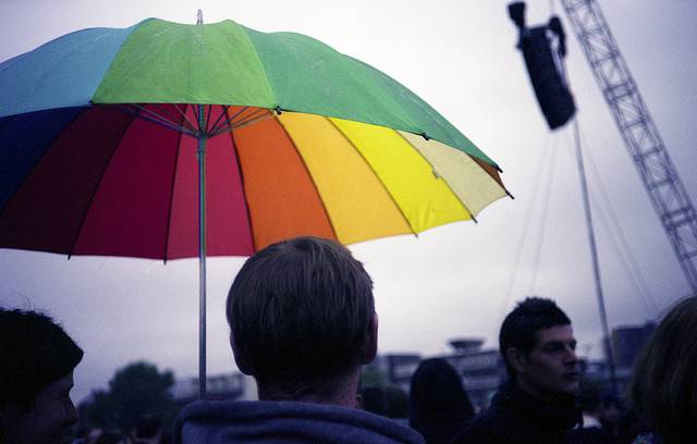 Man holding a colorful umbrella