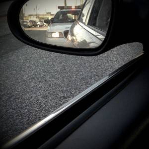 View of a police car from a side view mirror