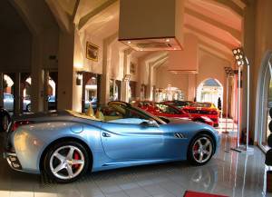 A modern light blue sports car in a car dealership