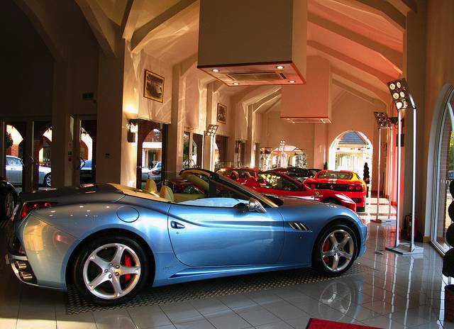 A modern light blue sports car in a car dealership