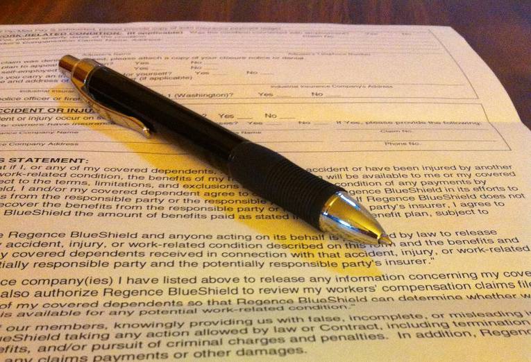 insurance form pen on a form placed on top a table