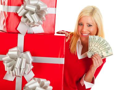 Stock Photo Woman showing money with a few gifts