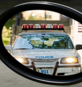 Rear mirror view of police car