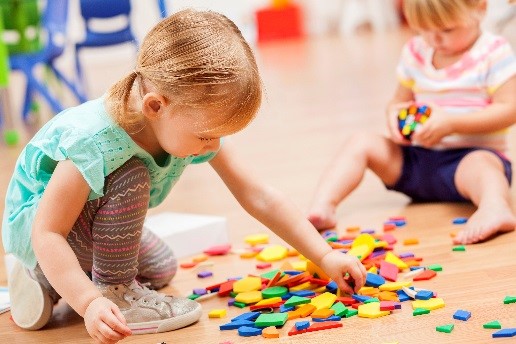 child playing with shaped blocks