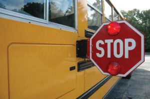 Yellow school bus with the stop sign engaged