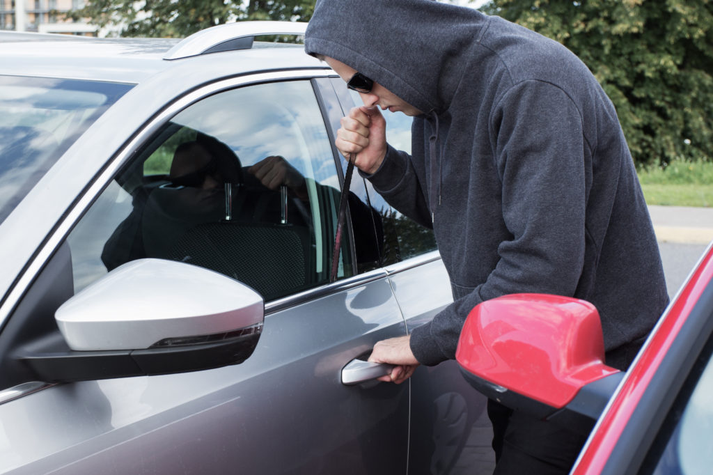 Thief breaking into a car