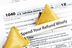 Tax return and fortune cookie reading "spend your refund wisely"